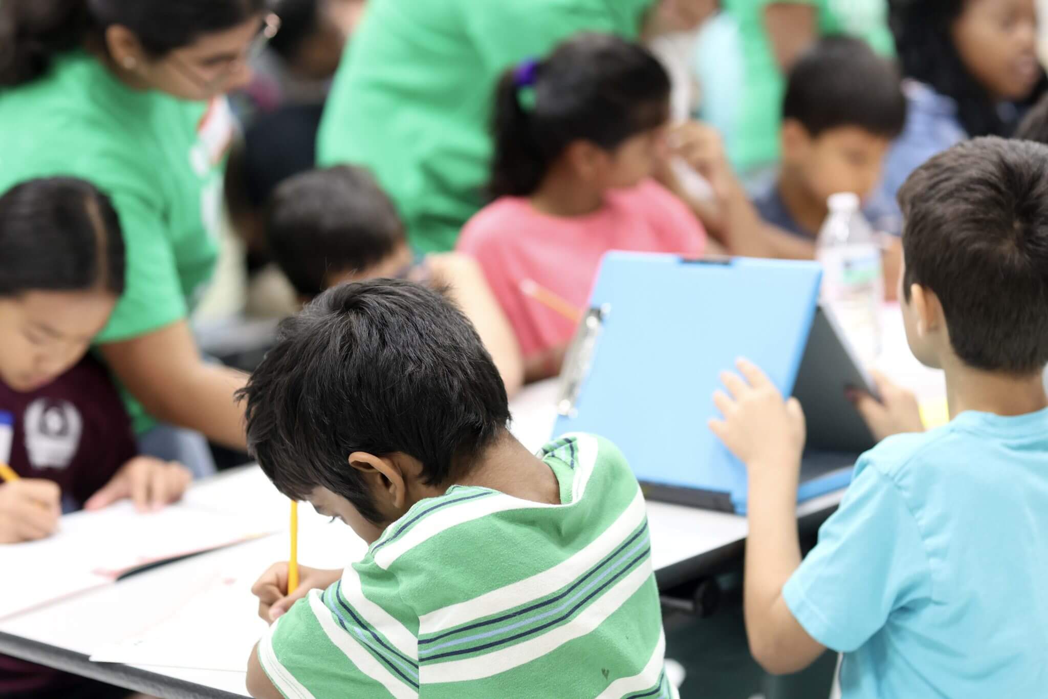 Children learning and collaborating in a creative classroom workshop environment.